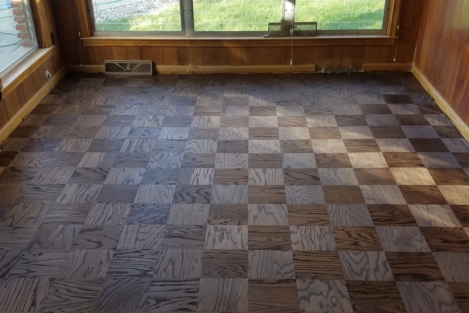 Parquet block flooring in a wood-paneled room